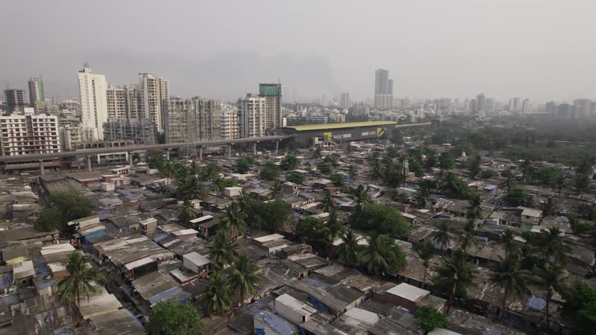 Tall skyscrapers loom over run down neighborhood