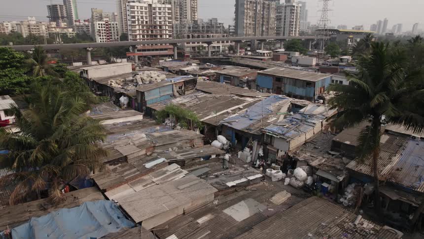 Overpass and power lines divided slums from apartment buildings on an overcast day