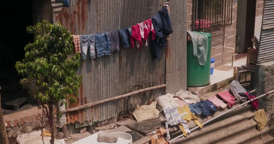 Clothes dries on metal wall panel and steps of building