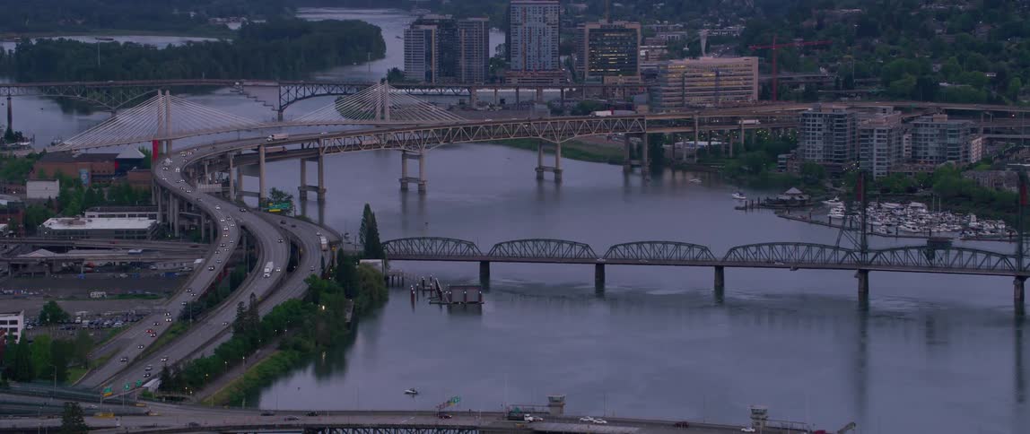 Drone view of a river going through a city with bridges crossing the water so traffic can travel across