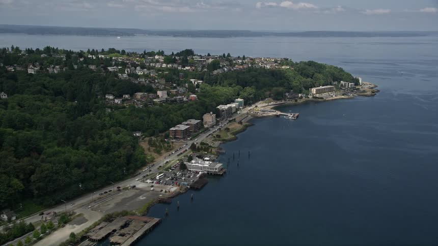 A stunning aerial view of waterfront apartment buildings and hilltop homes in West Seattle WA