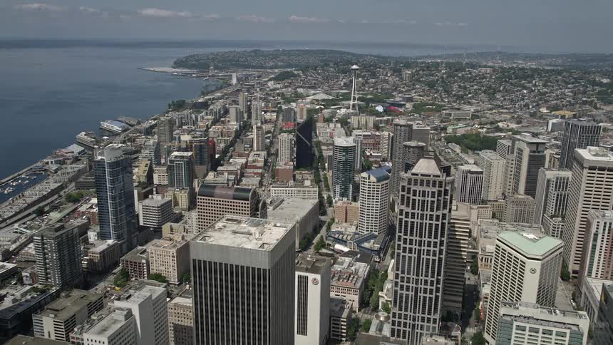 Approaching the Space Needle from above soar over downtown Seattles towering skyscrapers and iconic landmarks