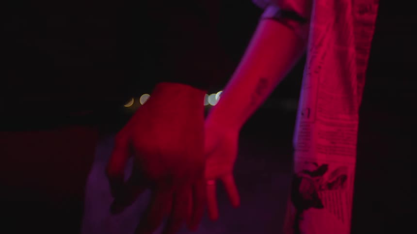 A man and a woman are holding hands but then let go