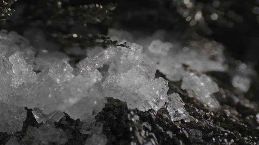 Salt crystals on a black stone formation