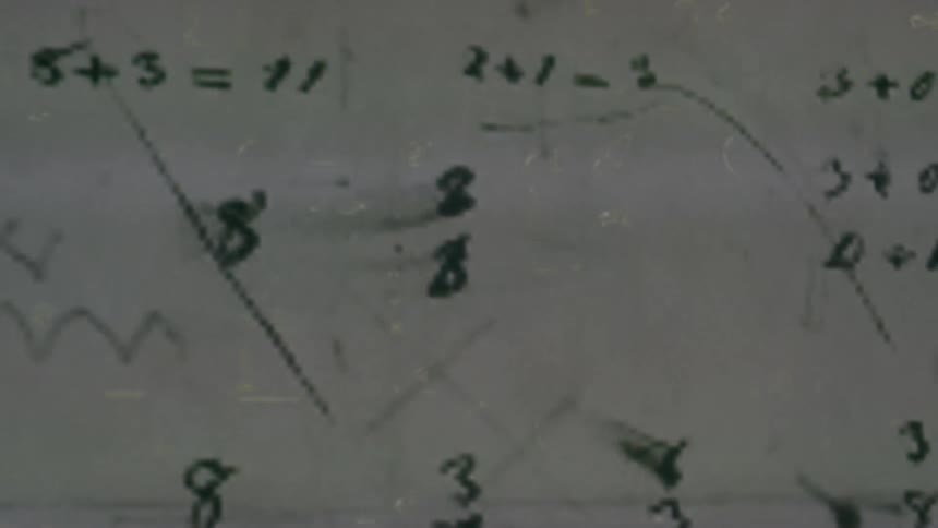 Mathematical equations written on a whiteboard while other equations and symbols flash over the board
