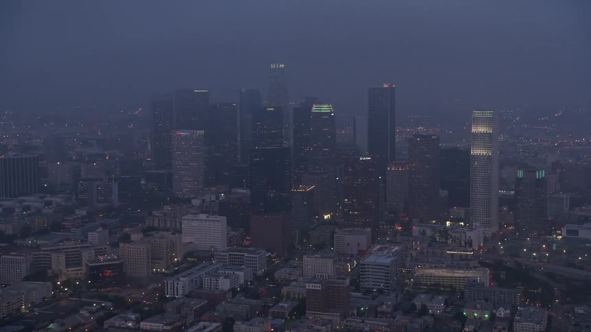 A mesmerizing 4K aerial footage of Los Angeles city shrouded in a marine layer of fog during twilight