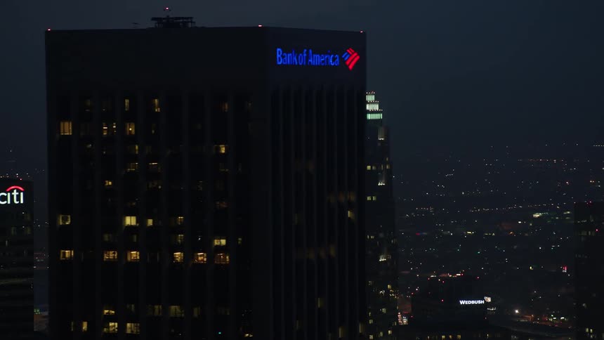 A stunning aerial view of illuminated high rise office buildings in the downtown area of Los Angeles during twilight