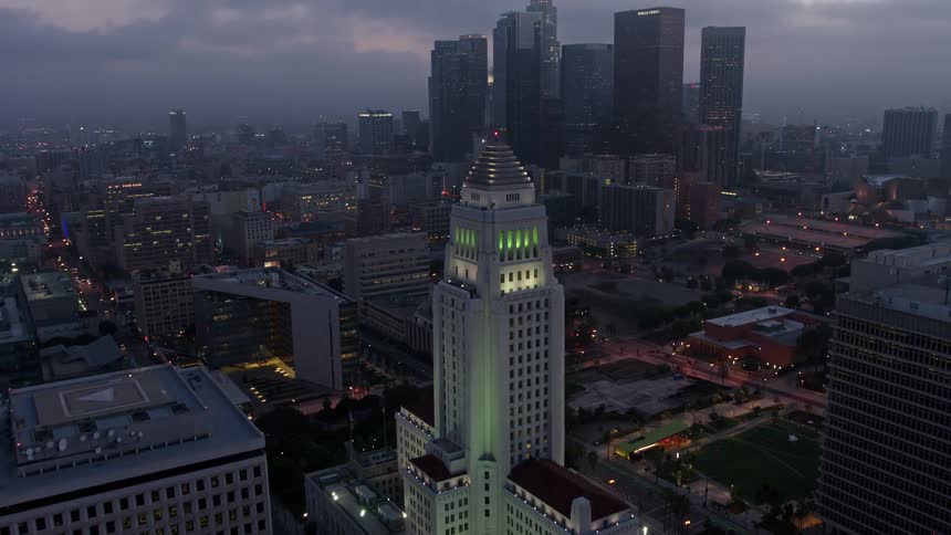 An aerial shot approaches City Hall and reveals the skyline of Downtown Los Angeles at twilight