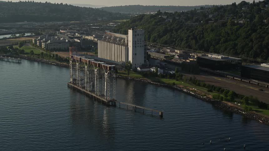 Aerial view of a grain elevator on the shoreline of Elliott Bay in Seattle Washington on a sunny day