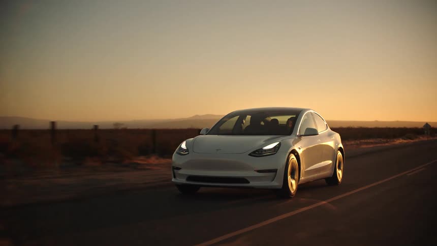 The sun is setting as the car drives