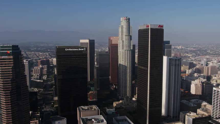 An aerial view of downtown Los Angeles high-rise towers including City National Plaza US Bank Tower and Aon Center approached by the camera