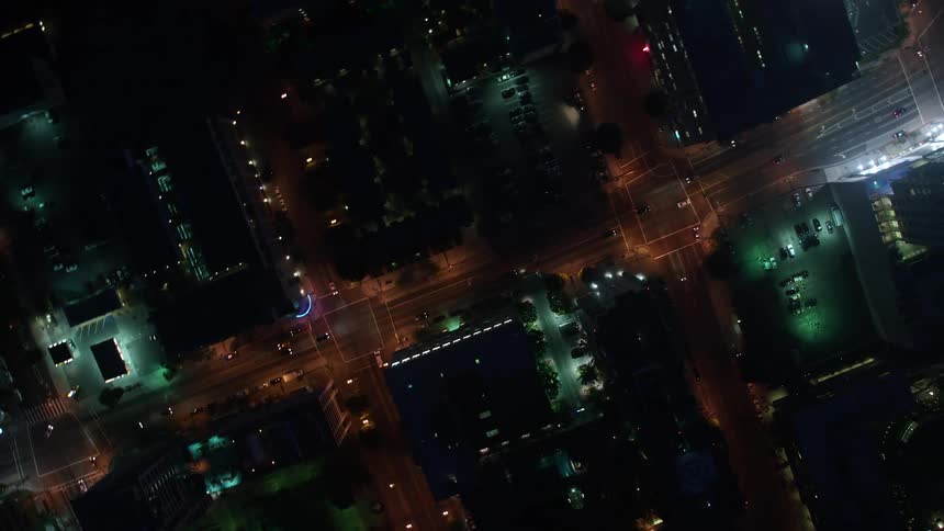 An aerial video of the illuminated streets and skyscrapers of Downtown Los Angeles showcasing the citys nightlife and entertainment scene