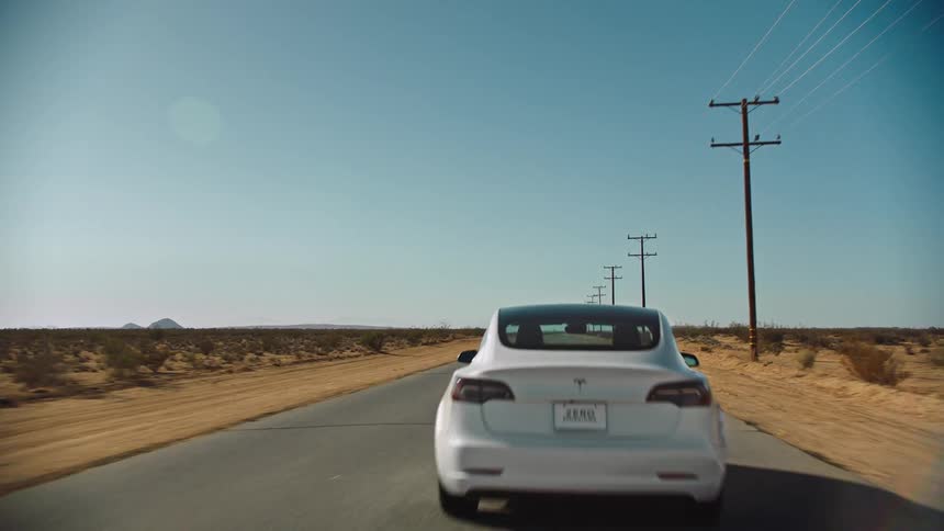 A car speeding down a desert road