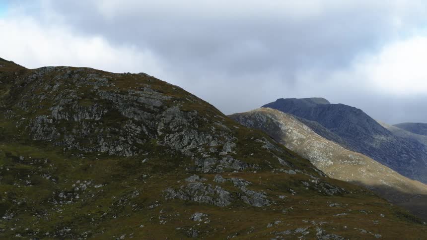 Aerial view of mountain range under clouds