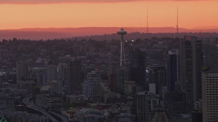 Aerial view of high rise buildings and tower at sunset in the city