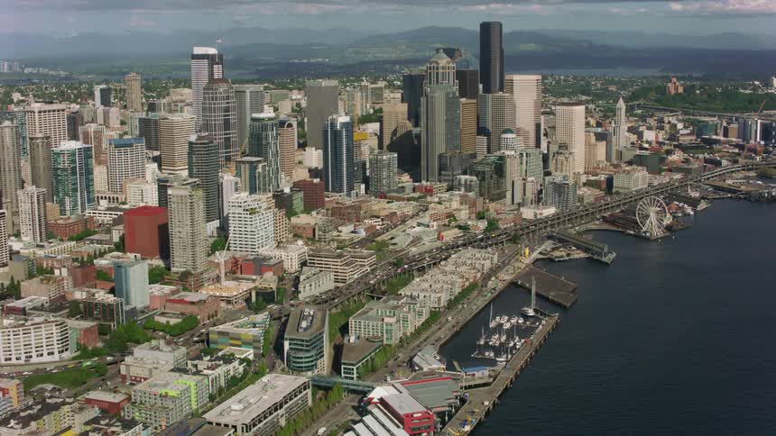 Skyscrapers of varying heights line a city along the coast