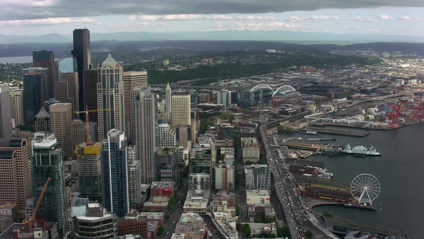 Aerial view of office buildings and skyscrapers next to sea in the city