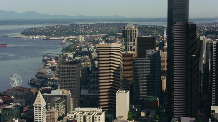 Traffic drives along highway between waterfront and downtown skyscrapers