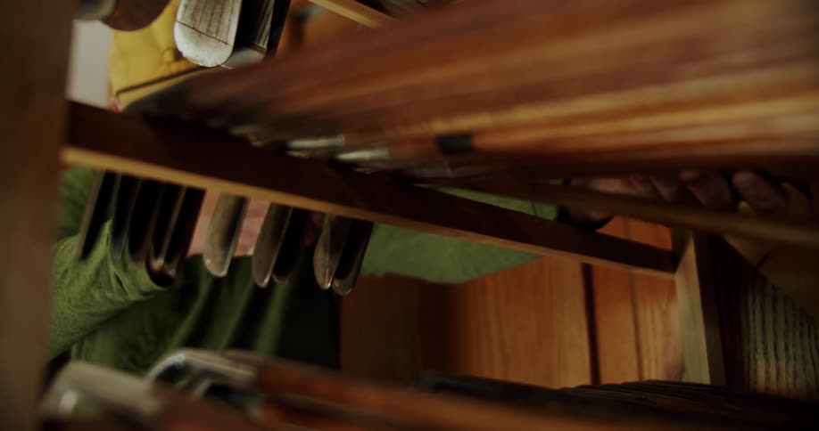 Man adds cluster of golf clubs to open frame storing golf clubs