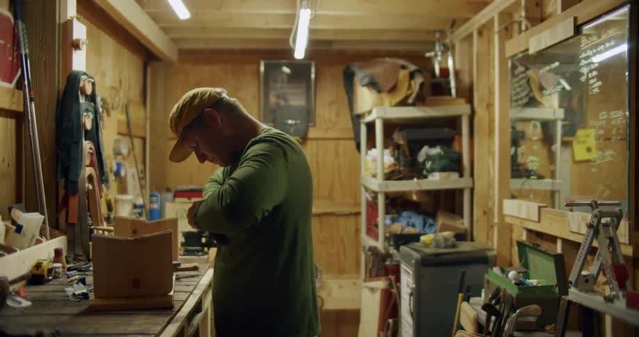 A man is repairing his golf club