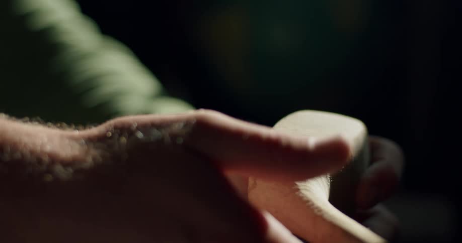 Close up of mans hands touching golf club