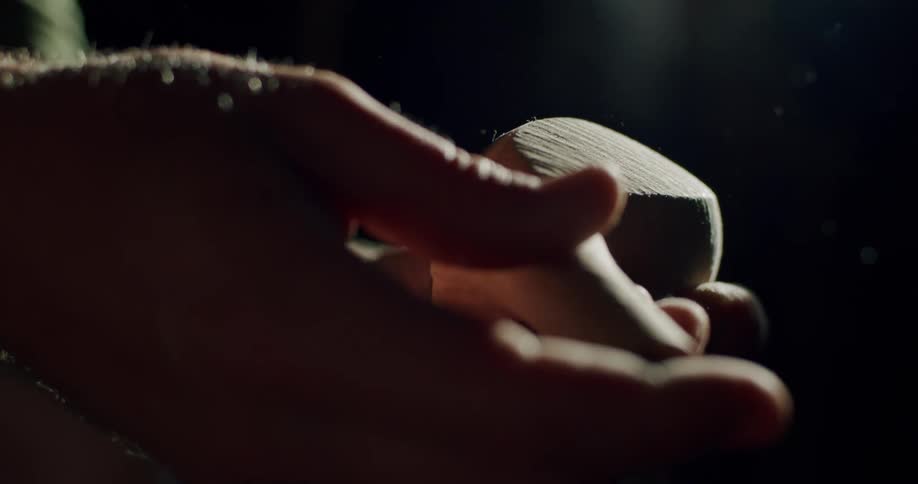 A close up of a person handling a wooden golf club head