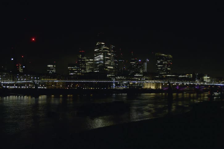 Landscape of illuminated bridge over river and city skyline