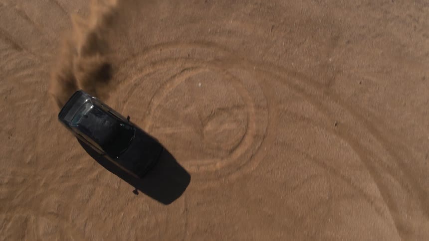 A car below is doing doughnuts