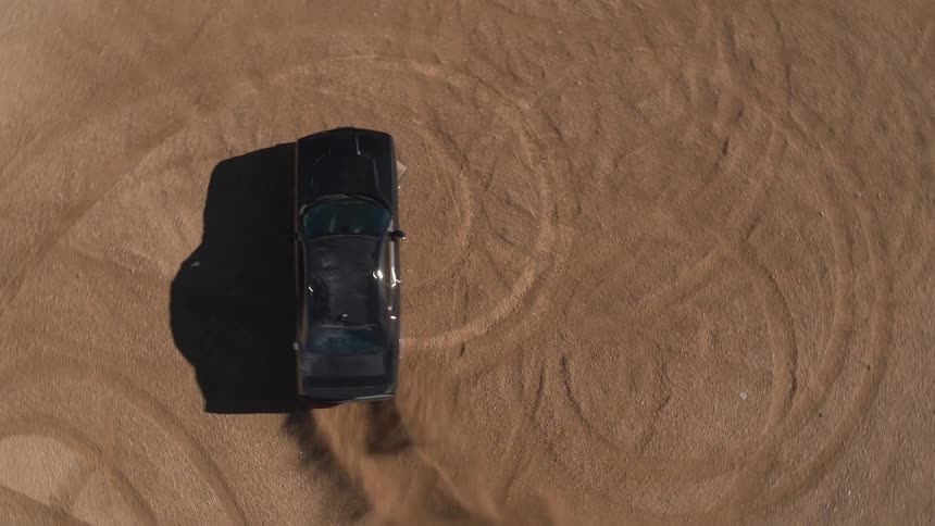 A black car is doing doughnuts