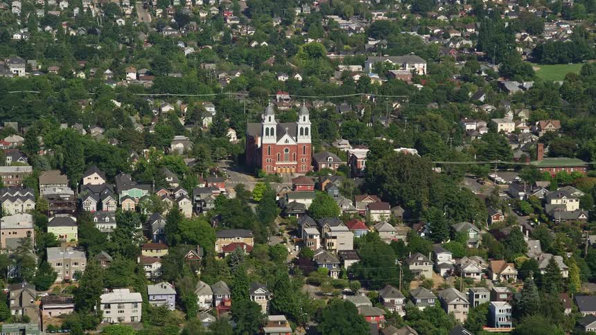 Approaching Immaculate Conception Church in a sunny urban residential area of Central Seattle Washington capturing the spiritual ambiance of the Catholic place of worship