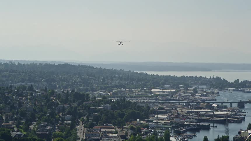 Aerial footage of a seaplane soaring above Queen Anne Seattle Washington on a sunny day