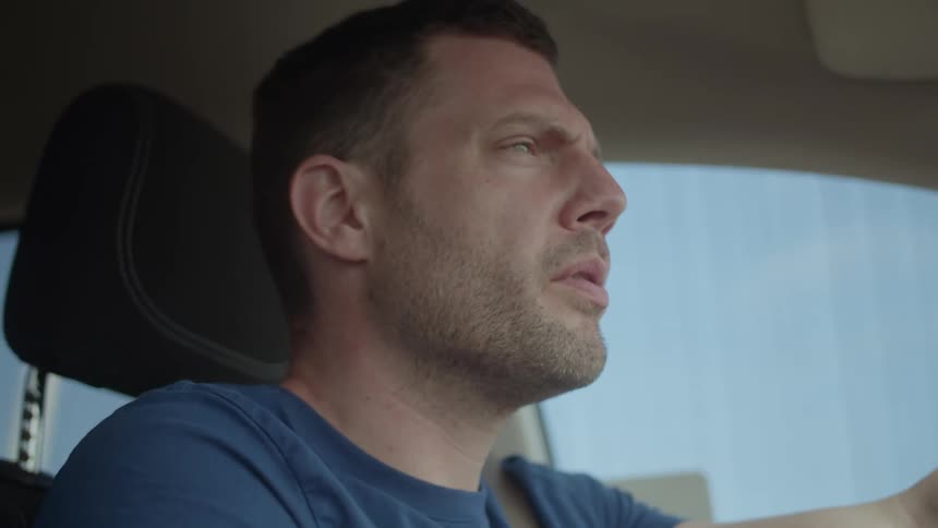 A man is driving his car