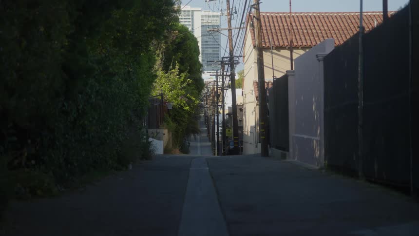 A street in a neighborhood with cars driving past