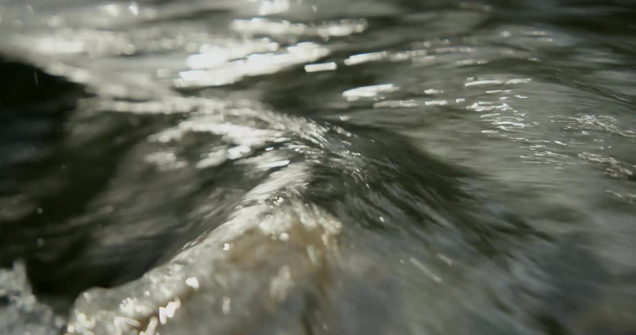 Running water churns slightly while flowing over rock