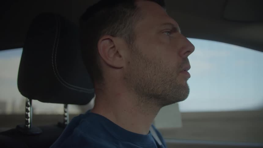 A man is driving a car