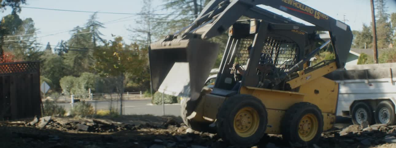 A man moves dirt with a bulldozer