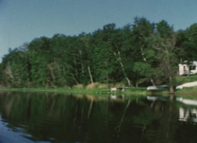A small building on the shore of a lake