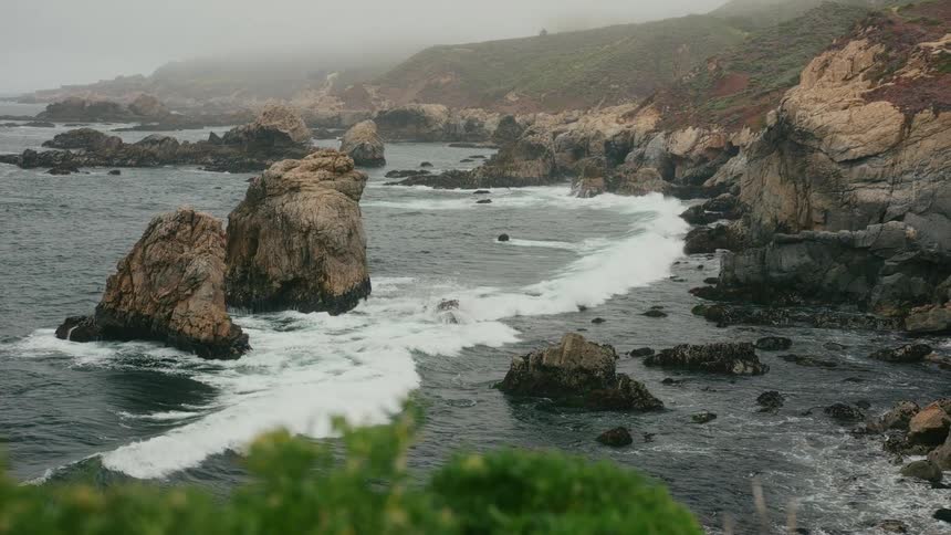 Waves crash onto the shore of a promontory