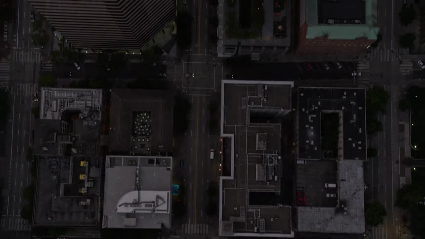 Aerial footage capturing the stunning bird's eye view of Downtown Seattle's 3rd Avenue at sunset passing by towering skyscrapers and city streets