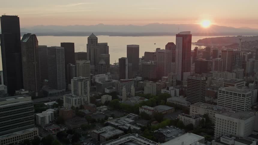 Passing skyscrapers in downtown Seattle during a stunning sunset over Elliott Bay