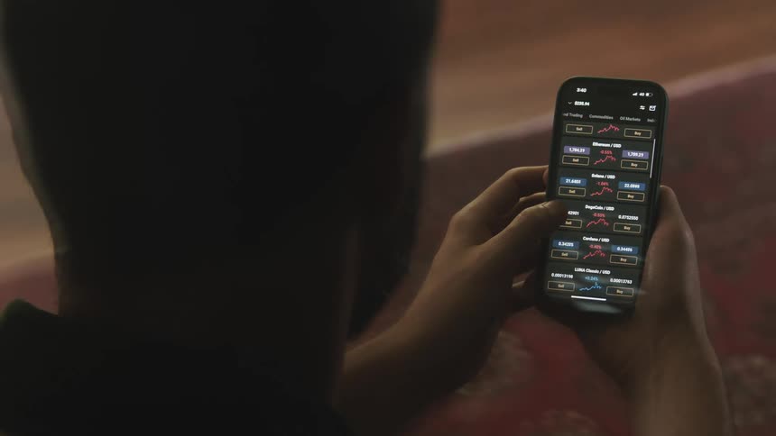 A man using a smartphone in a room