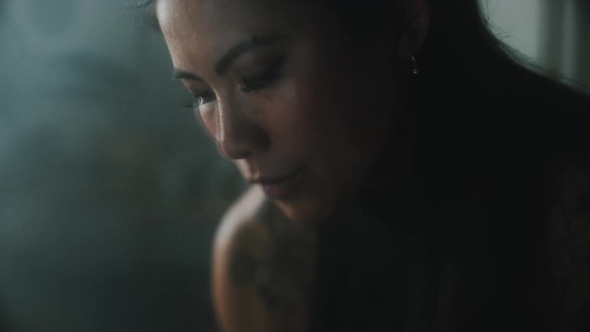 Close up view of a woman sitting in her house