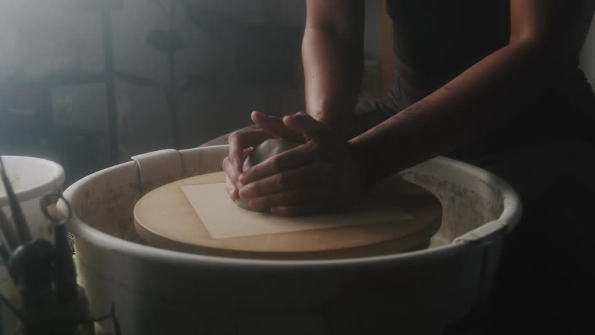 A person is sculpting clay
