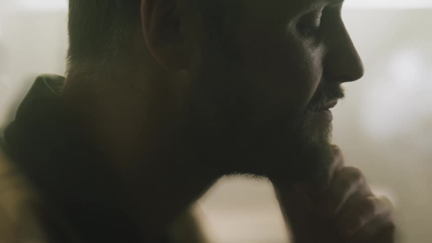 A man rubs his chin thinking