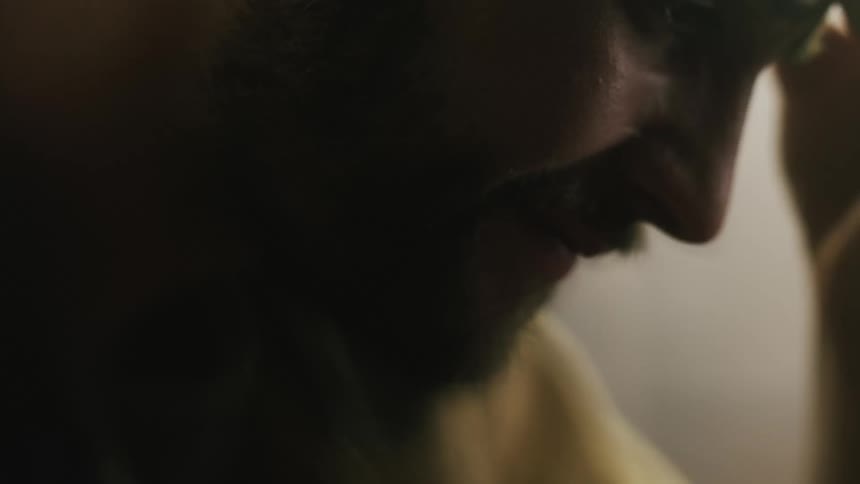 The view is of a man that is inside and looks sad
