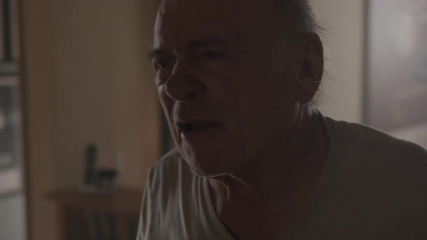 Angry elderly man throughs clothes and gestures
