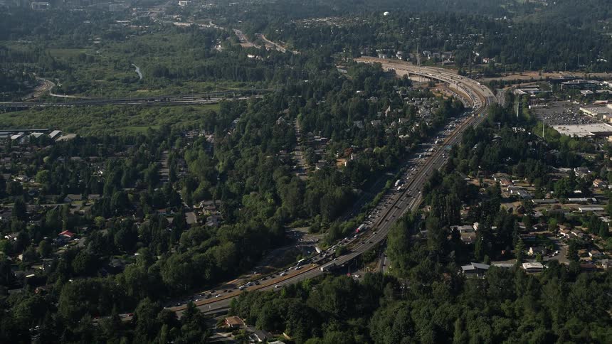 Traffic congestion fills the multi-lane highway passing through a suburban neighborhood in Bellevue Washington