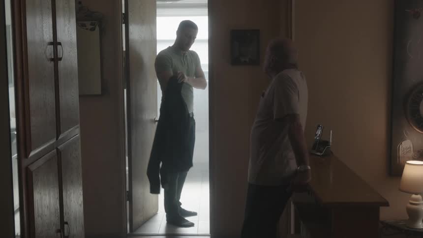 An elderly man goes to talk to his son before he leaves the house