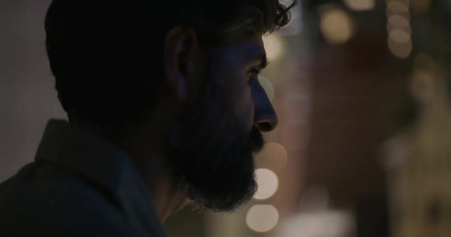 A man looks around at night