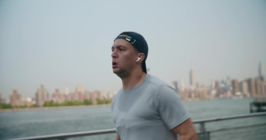A man is jogging by the water